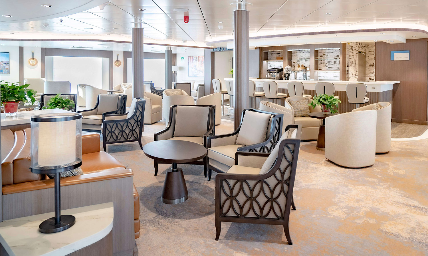 A lounge room with bar, tables and chairs on a luxurious cruise ship.